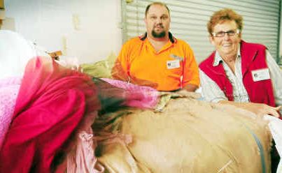 New beginnings: Salvation Army Op Shop volunteer Phyllis Taylor and staff member Graham Ettridge with reject clothing that will be sent to Africa. New beginnings: Salvation Army Op Shop volunteer Phyllis Taylor and staff member Graham Ettridge with reject clothing that will be sent to Africa.